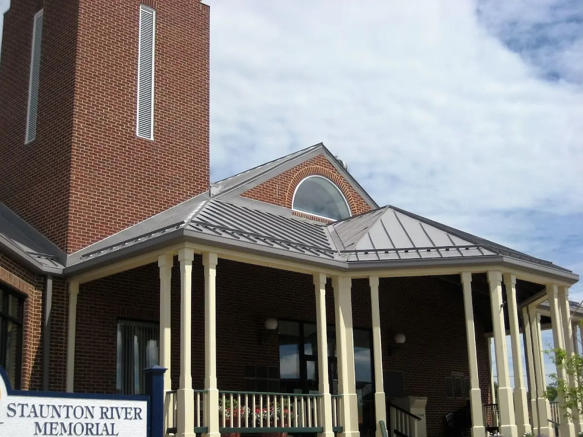 Skilled roofing craftsmen working on a residential roof in Rensselaer